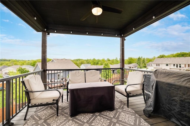 wooden terrace with ceiling fan, a residential view, and a grill