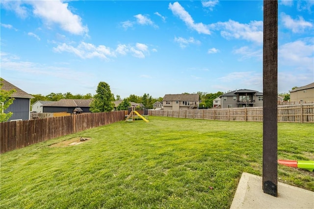 view of yard featuring a playground and a residential view