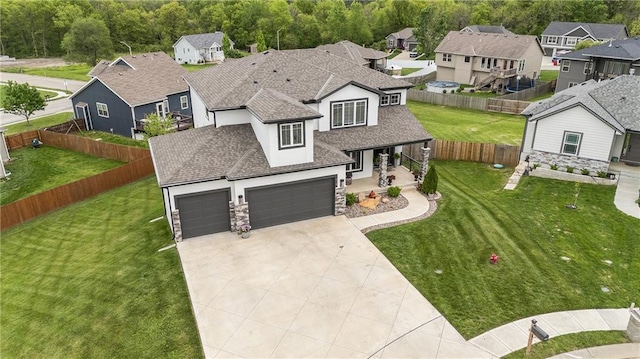 view of front of property featuring stucco siding, a residential view, driveway, and stone siding