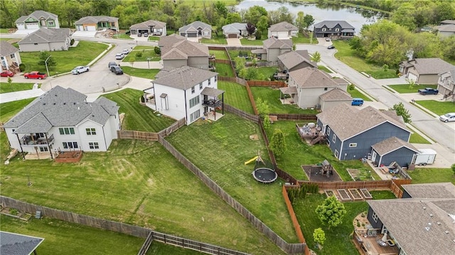 aerial perspective of suburban area with a nearby body of water