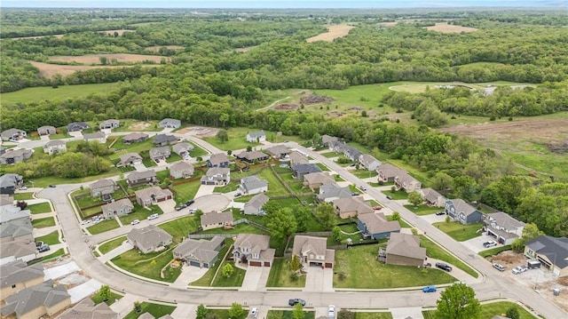 aerial overview of property's location with nearby suburban area and a heavily wooded area
