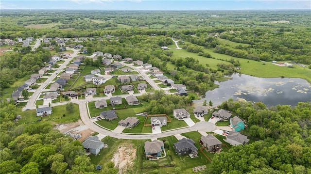 aerial view of property's location with a nearby body of water, a heavily wooded area, and nearby suburban area