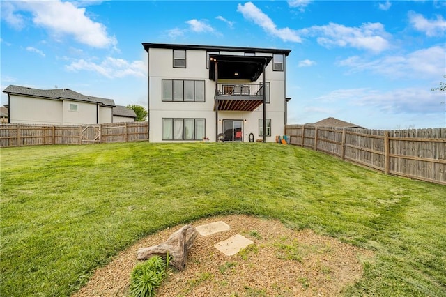 809 N Maple Ct, Lone Jack, MO 64070 - rear view of house with a fenced backyard, stucco siding, and a balcony