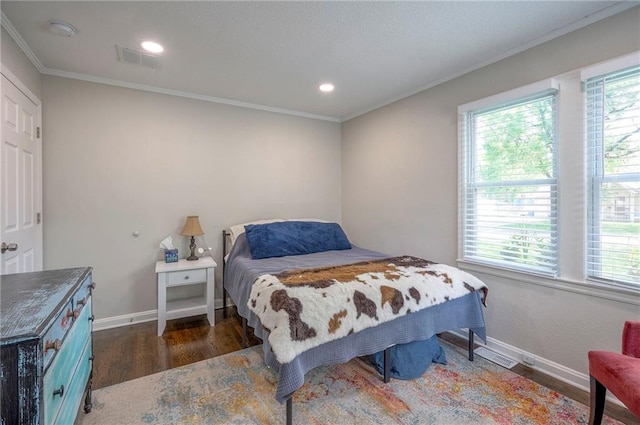 bedroom with ornamental molding, wood finished floors, baseboards, and recessed lighting