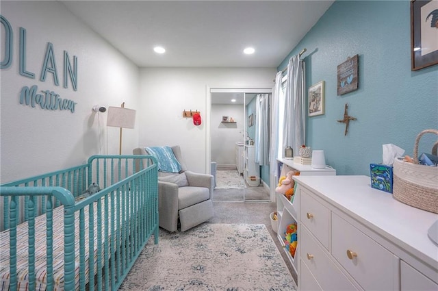 bedroom featuring recessed lighting and a crib