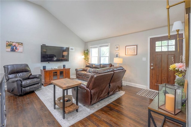 living room featuring wood finished floors, lofted ceiling, and baseboards