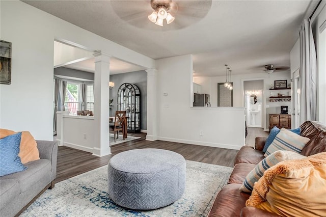 1849 W Cedar St, Olathe, KS 66061 - living area with a ceiling fan, wood finished floors, and ornate columns