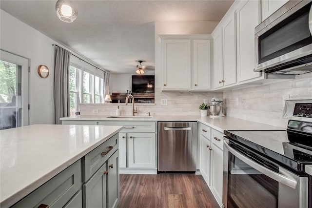 1849 W Cedar St, Olathe, KS 66061 - kitchen with stainless steel appliances, healthy amount of natural light, light countertops, and backsplash