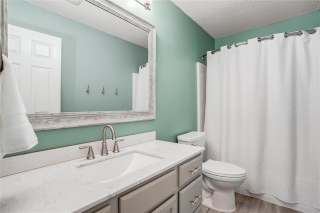 1849 W Cedar St, Olathe, KS 66061 - full bathroom with a textured ceiling, vanity, wood finished floors, and curtained shower