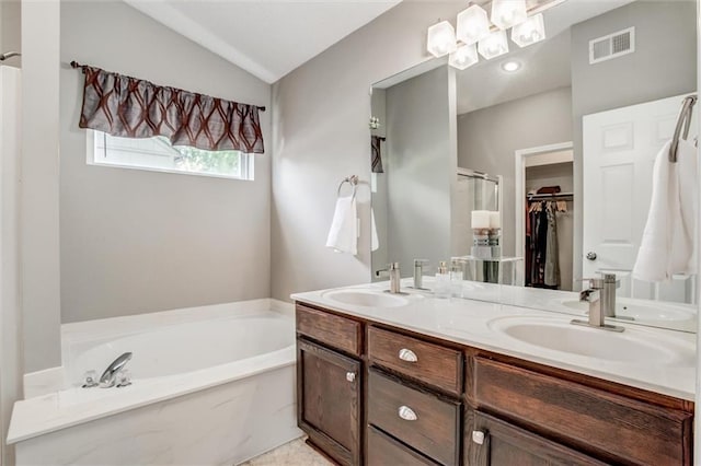 1849 W Cedar St, Olathe, KS 66061 - full bathroom with a garden tub, double vanity, a spacious closet, a shower stall, and lofted ceiling