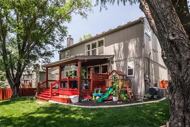 1849 W Cedar St, Olathe, KS 66061 - back of house featuring a chimney, a playground, and a deck