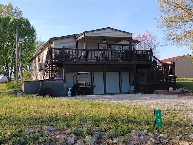 33 Lakeview Ln, Linn Valley, KS 66040 - rear view of property with stairway, a deck, and dirt driveway