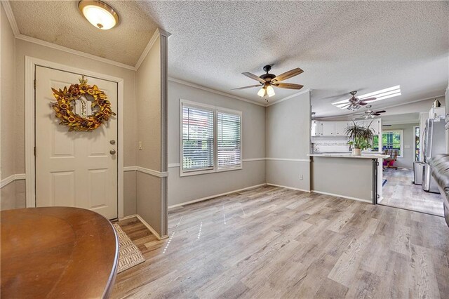 33 Lakeview Ln, Linn Valley, KS 66040 - entrance foyer with ornamental molding, plenty of natural light, ceiling fan, light wood-type flooring, and a textured ceiling