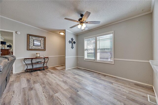 33 Lakeview Ln, Linn Valley, KS 66040 - unfurnished room featuring crown molding, a textured ceiling, wood finished floors, a ceiling fan, and baseboards