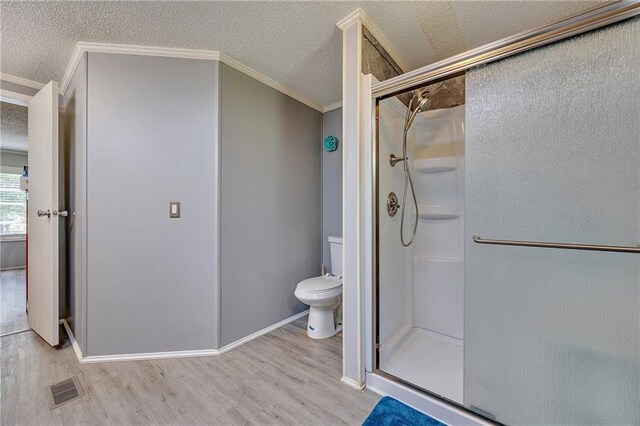33 Lakeview Ln, Linn Valley, KS 66040 - bathroom featuring ornamental molding, a shower stall, wood finished floors, toilet, and a textured ceiling