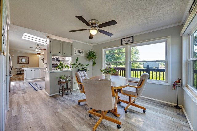 33 Lakeview Ln, Linn Valley, KS 66040 - dining space with ceiling fan, plenty of natural light, light wood-style floors, a textured ceiling, and crown molding