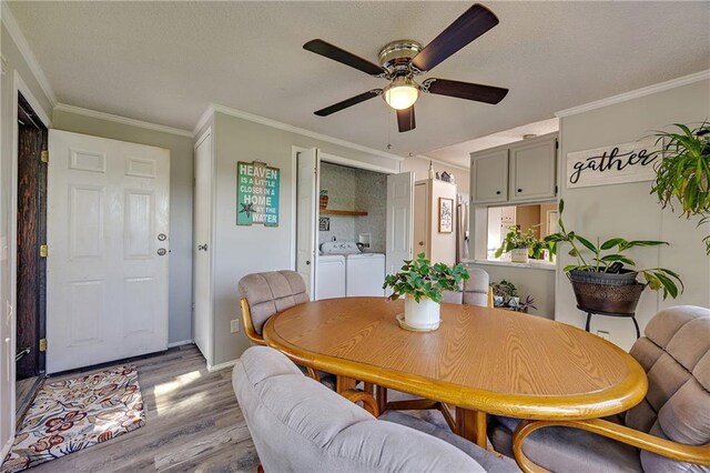 33 Lakeview Ln, Linn Valley, KS 66040 - dining area featuring washer and clothes dryer, wood finished floors, ceiling fan, ornamental molding, and baseboards