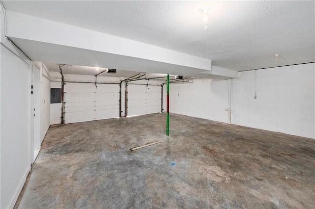 garage featuring electric panel and a garage door opener