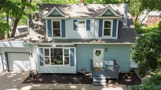 506 W 86th St, Kansas City, MO 64114 - view of front of home with a garage, a shingled roof, a chimney, and driveway