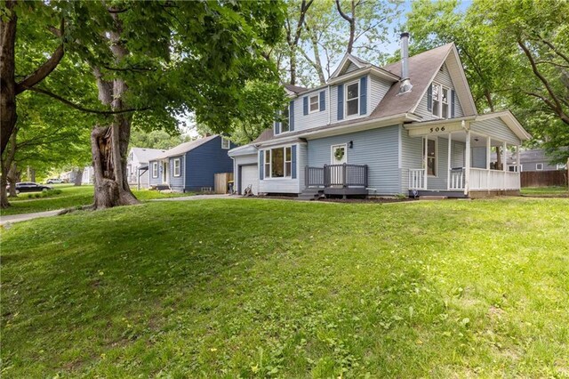 506 W 86th St, Kansas City, MO 64114 - view of front facade featuring an attached garage, a porch, and a front lawn