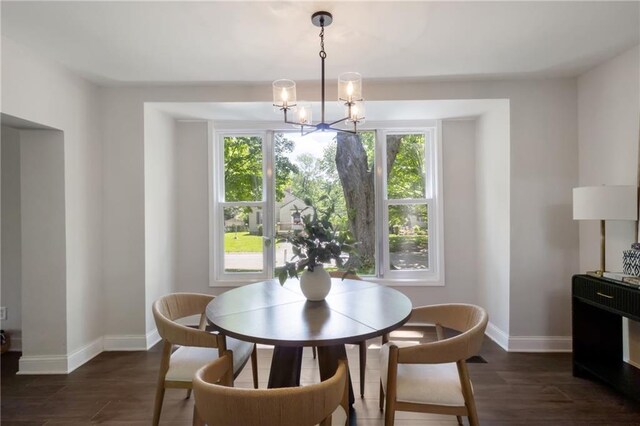 506 W 86th St, Kansas City, MO 64114 - dining area featuring a chandelier, baseboards, and dark wood-style floors
