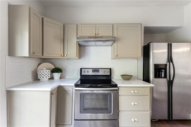 506 W 86th St, Kansas City, MO 64114 - kitchen featuring appliances with stainless steel finishes, under cabinet range hood, light countertops, and tasteful backsplash