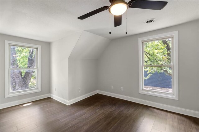 506 W 86th St, Kansas City, MO 64114 - additional living space with baseboards, healthy amount of natural light, ceiling fan, dark wood-type flooring, and vaulted ceiling