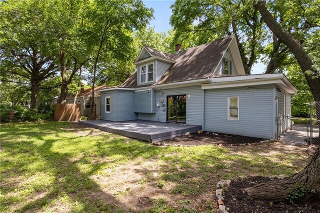 506 W 86th St, Kansas City, MO 64114 - back of house with a deck and a chimney