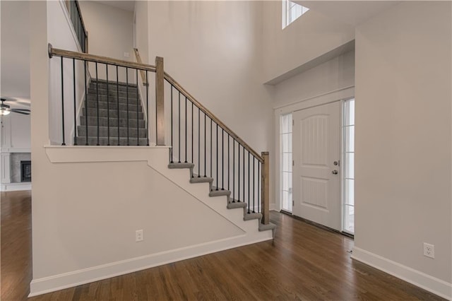 6106 NE 118th St, Kansas City, MO 64156 - entrance foyer featuring stairway, wood finished floors, a high ceiling, ceiling fan, and baseboards