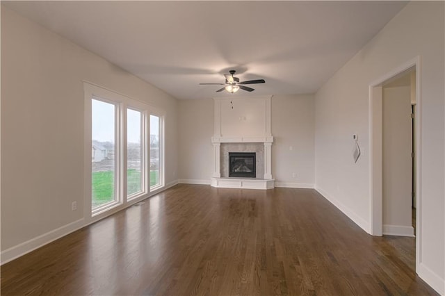 6106 NE 118th St, Kansas City, MO 64156 - unfurnished living room with dark wood-style flooring, a tile fireplace, a ceiling fan, and baseboards