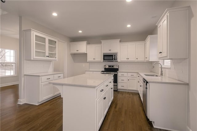 6106 NE 118th St, Kansas City, MO 64156 - kitchen with stainless steel appliances, a sink, dark wood-type flooring, white cabinets, and recessed lighting
