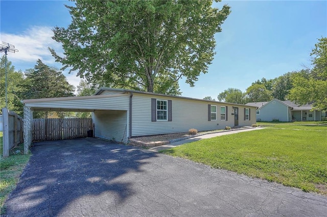 507 W 26th St, Higginsville, MO 64037 - view of front of property featuring asphalt driveway and an attached carport