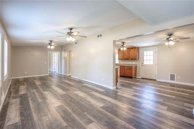 507 W 26th St, Higginsville, MO 64037 - unfurnished living room with dark wood-style floors, ceiling fan, and baseboards