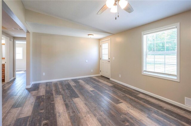 507 W 26th St, Higginsville, MO 64037 - empty room with ceiling fan, dark wood-style flooring, healthy amount of natural light, and baseboards