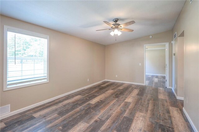 507 W 26th St, Higginsville, MO 64037 - spare room featuring ceiling fan, dark wood-style flooring, and baseboards