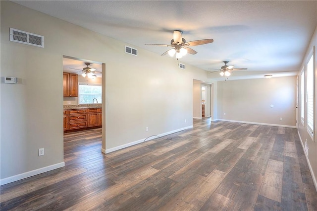 507 W 26th St, Higginsville, MO 64037 - spare room with a ceiling fan, dark wood finished floors, and baseboards