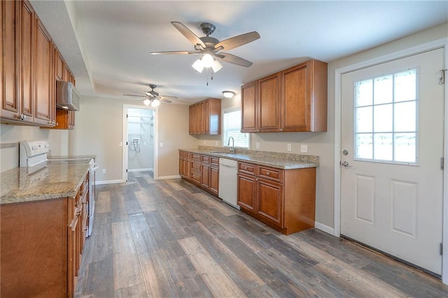 507 W 26th St, Higginsville, MO 64037 - kitchen with white appliances, brown cabinetry, a sink, a ceiling fan, and baseboards