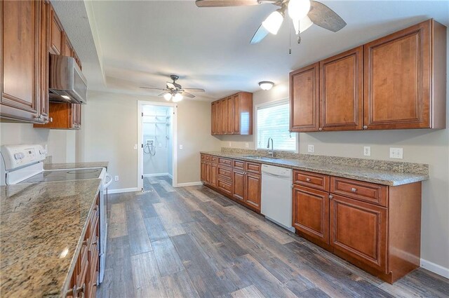 507 W 26th St, Higginsville, MO 64037 - kitchen with white appliances, a ceiling fan, brown cabinetry, and a sink