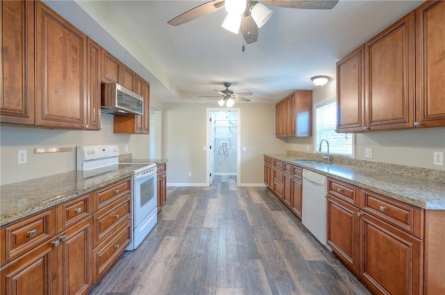 507 W 26th St, Higginsville, MO 64037 - kitchen with white appliances, a ceiling fan, a sink, dark wood finished floors, and brown cabinets