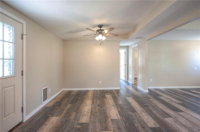507 W 26th St, Higginsville, MO 64037 - empty room with ceiling fan, dark wood-type flooring, and baseboards