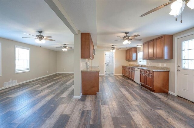 507 W 26th St, Higginsville, MO 64037 - kitchen with white dishwasher, brown cabinetry, baseboards, and dark wood-type flooring