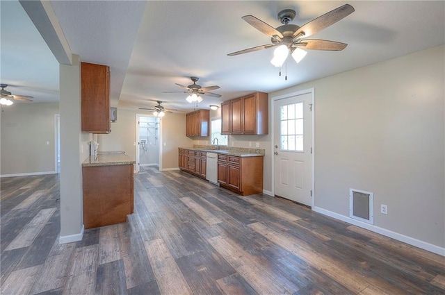 507 W 26th St, Higginsville, MO 64037 - kitchen with white dishwasher, ceiling fan, brown cabinets, baseboards, and dark wood-type flooring