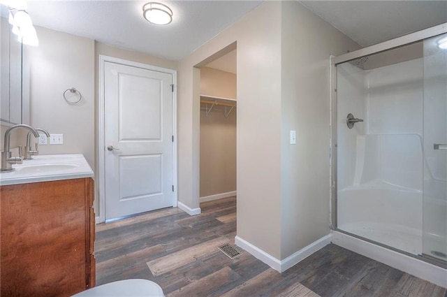 507 W 26th St, Higginsville, MO 64037 - full bath with a shower stall, wood finished floors, baseboards, and vanity