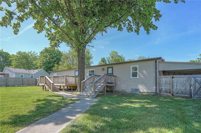 507 W 26th St, Higginsville, MO 64037 - rear view of house featuring a deck and a gate