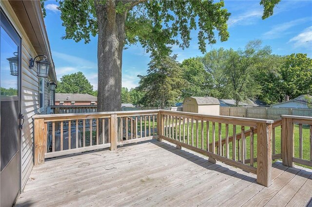 507 W 26th St, Higginsville, MO 64037 - wooden terrace with a shed, an outbuilding, and a fenced backyard