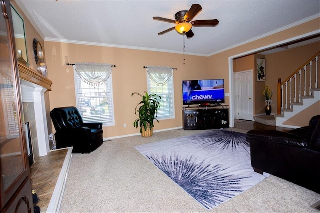 16366 S Hunter St, Olathe, KS 66062 - carpeted living room with a fireplace with raised hearth, stairs, ornamental molding, a ceiling fan, and baseboards