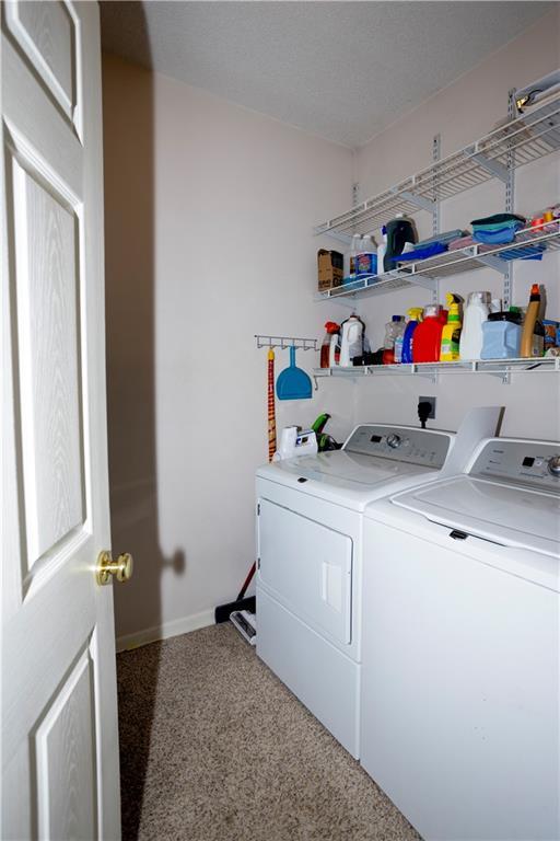 16366 S Hunter St, Olathe, KS 66062 - washroom with washer and dryer and baseboards
