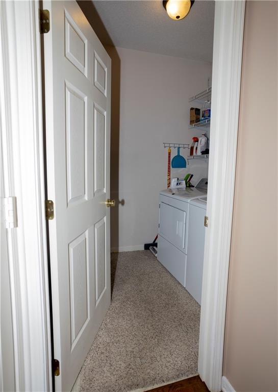 16366 S Hunter St, Olathe, KS 66062 - laundry room featuring independent washer and dryer, dark carpet, and baseboards