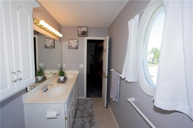 16366 S Hunter St, Olathe, KS 66062 - bathroom featuring double vanity and baseboards