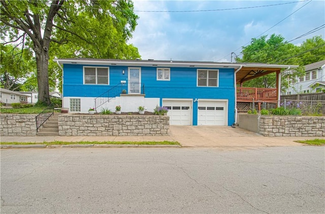 4547 Wyoming St, Kansas City, MO 64111 - ranch-style house featuring stairway, driveway, and an attached garage